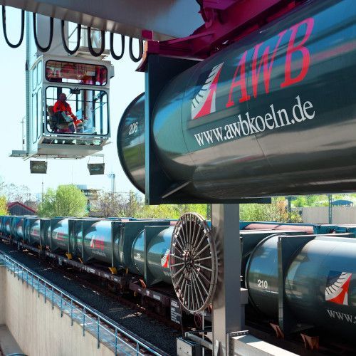 In einem Verladekran sitzt ein Mitarbeiter der AWB. Im Vordergrund ist ein zylinderf&ouml;rmiger Kontainer mit der Aufschrift AWB